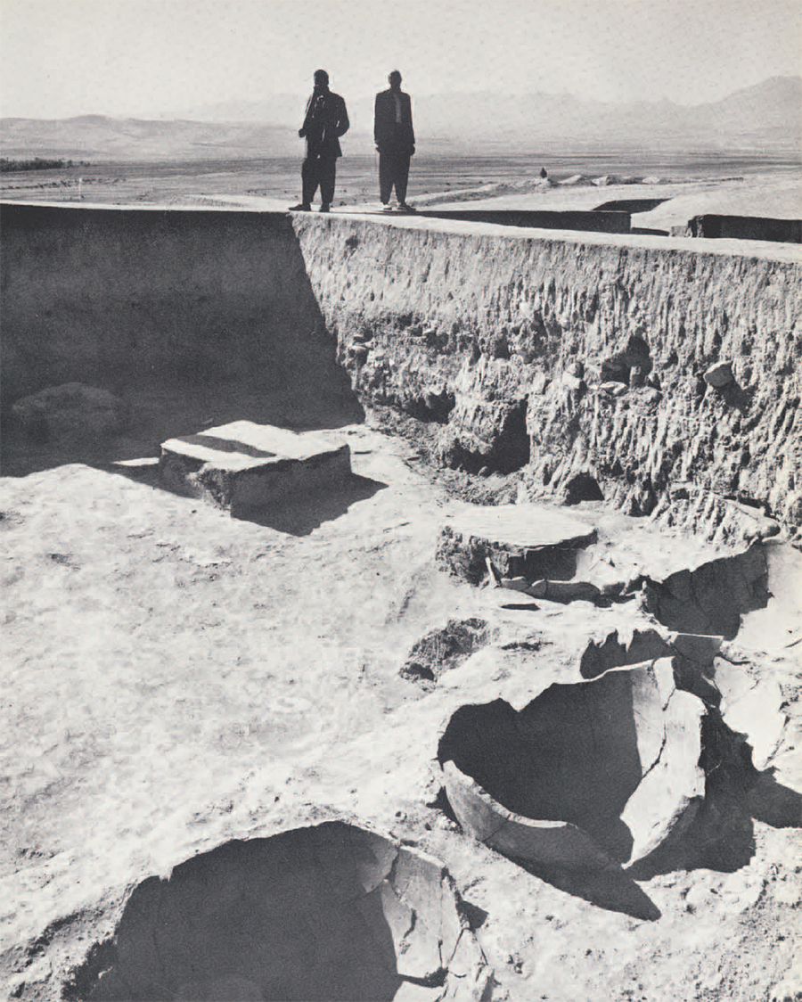 image of Burned Building, men standing on edge.
