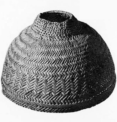 A domed, woven rattan hat with an opening at the top.