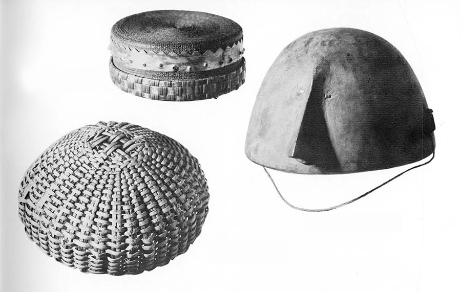 Three hats, two woven and one carved of wood.