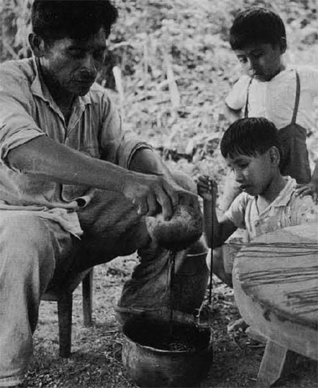 Photo of man making candles with children