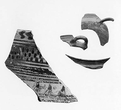 (Left) Fragment from the wall of pyxis of imported Corinthian ware. It was found in the sand south of the Greek wall in Test Pit A, and is datable to before 650 B.C. A pyxis is a cylindrical pottery container for cosemetics of other feminine knickknacks. Height, which is preserved complete, about 2½ inches. (Right) Handles and rim fragments of archaic banded cups which were a common ware in South Italy of the late seventh and sixth centuries B.C. These were picked from the dump of the scoop-shovel, brought up from about 6-meter level in Pit A. 