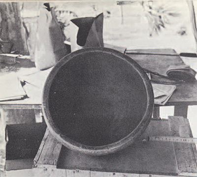 The first Tikal field laboratory, in 1957, in a corner of the Project's garage and tool shop. A pottery vessel is set up for a record photograph.