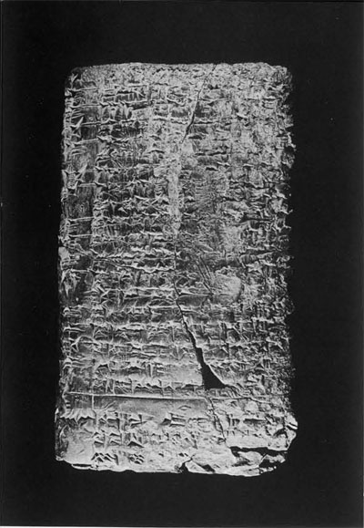 Tablet covered in lines of cuneiform inscriptions and a seal impression.