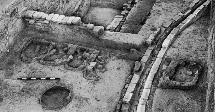 An excavated area showing drains and altars.