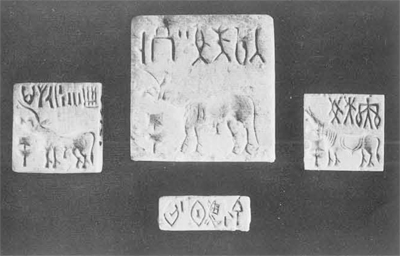 Four rectangular seals, three of which sohwing a horned animals beneath inscriptions.
