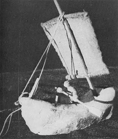 A reconstruction of a model of a crude ship with a sail and small person steering.