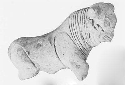 A bull figurine, missing horns and legs.