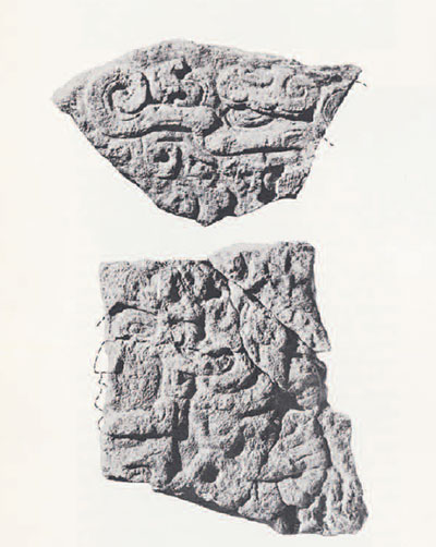 Two fragments with intricate carvings on them.