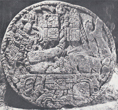 Round stone altar depicting a tied up figure.