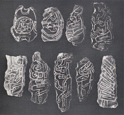 Nine pieces of obsidian with incised patterns.