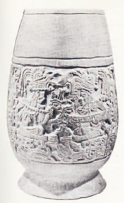 Egg shaped vessel with foot, a band of carving around the middle.