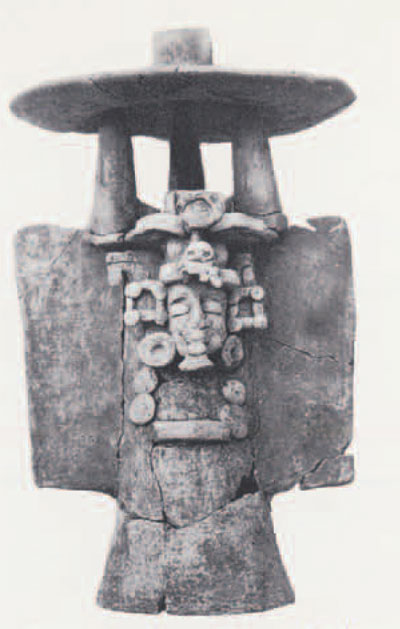 Late Preclassic pottery incense burner with the modeled face of the Maya "old god" recovered from a ceremonial cache within the ramp of Mound 1.
