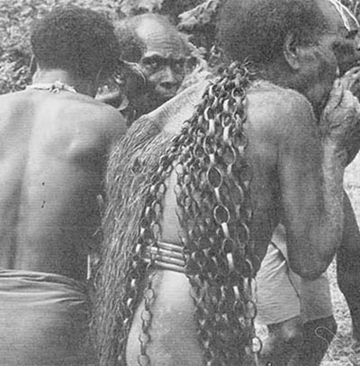 The same Kwaio warrior seen in page 35, #3 The woven chain down his back is a mark of prestige: each link represents a pig he of his father successfully stole in their careers the chain is donned on special occasions after retirement from the game of pig stealing. 