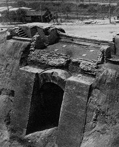 In the course of dismantling the city gates and walls of the Ming period in Peking, workers discovered the the barbican entrance to the Ho-yi gate of Tatu, the ancient capital of the Yüan dynasty, had been retained below the Ming structure in fairly good condition. In China, city walls are usually built of rammed earth, but the picture shows that the outer gateway was faced with fired bricks and the arched gateway built entirely of bricks. Similar to the watchtowers along the Great Wall there were three rooms above the gate; the stairways are still visible on both sides. A new feature apparently not seen in an earlier city gate tower was cistern city gate placed on the western (outside) wall of the floor of the gate tower. It had two shallow chambers , one on each side, and the water could run through two round stones with five holes just above the wooden gate, to defend it against attack by fire. Among graffiti on the walls of the tower was one written a workman and dated A.D. 1385. The tower is still 22 meters high, the arched gateway 10 meters long, 6.62 meters wide and 6.69 high. Yüan dynasty, built A.D. 1385. Kaogu 1972. No.1, Pl. 8. 