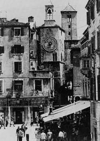 A view of Split showing, from left to right, an nineteenth century building, a medieval Venetian tower, the Roman gateway surmounted by an early medieval bell tower, and on the right, more modern buildings. (town Planning Institute.)