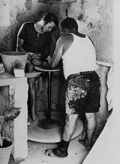 The author working at the turnable with a potter on the island of Rhodes.