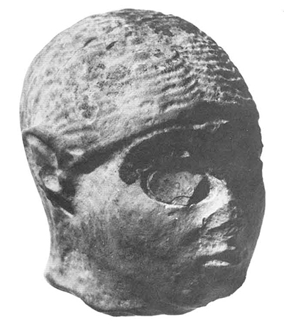 Head of stone statue found in the same room as the cylinder seals. H. 3.5 cm. 