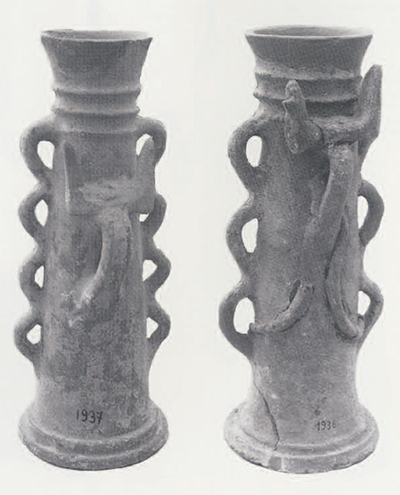 5a,b Late Minoan cylindrical stands from Gournia on Crete (Archaeological Museum, Herakleion, nos, 1937 and 1936). Serpentine loop handles and horns of consecration are indicative of religious use. The association of these of these cylinders with goddess figurines in a shrine context confirms their cultic connection. The rings around the top are base and the serpentine elements have parallels in later cylinders from Beth Shan. (1937, height 38 cm.; 1936, height 40.5 cm.)