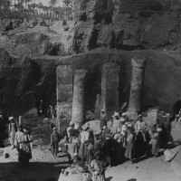 General view showing progress of the excavations in 1915. The columns and pylon of Merenptah's palace are in the background, while two doorjambs are visible in the foreground.