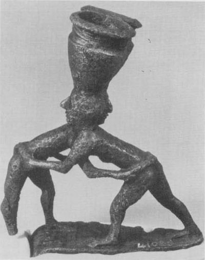 Statuette from Khafaji, Iraq, showing two wrestlers grasping easch other's girdles; ca 2600 B.C.E.
