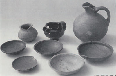 Group of Middle Phrygian pots found inside two large storage jars in 1989. The round-bodied jar and the exterior of the two bowls had non-alphabetic marks. A third bowl had an alphabetic inscription (fig 13a). (Photo by L. Foos, courtesy of the Gordion Project)