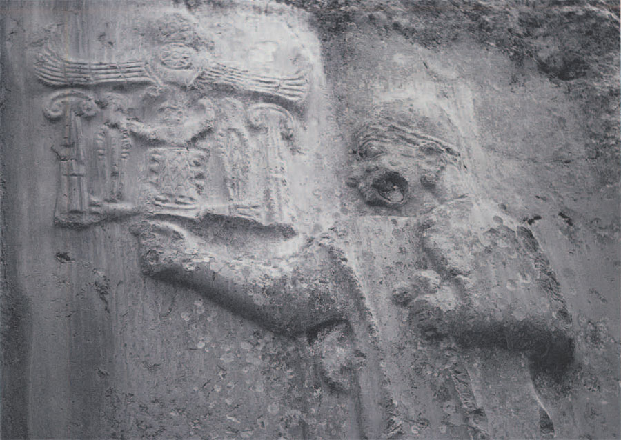 Relief of King Tuthaliyah within the rock shrine of Yazilikaya at Bogazkoy, Turkey. The relief is approximately contemporary with the Later Bronze Age settlement at Gordion. In the upper lefthand corner is the king's name written in the hierglyphic script employed at the Hittite capital H. of relief 2.95m. (Phot courtesy of M.M. Voight.)