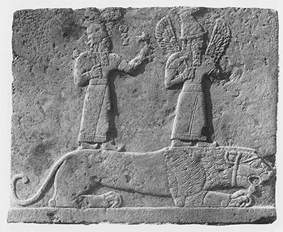 Relief showing two gods standing over a prone lion.