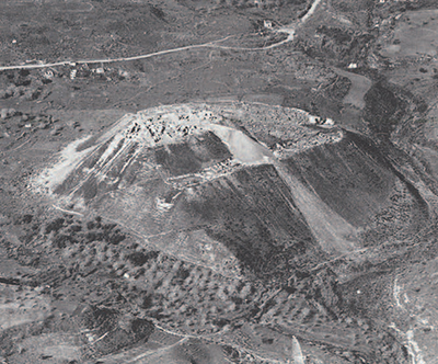 Aerial view of Tell el-Husn, ancient Beth Shan, taken in 1924 by British Royal Air Force, looking east across the Jezreel Valley. The small village of Beisan, not visible in this view, is to the left of the tell. The well-preserved Roman city, ancient Scythopolis, at the base of the tell is currently a major focus of excavation by the Israel Ministries of Tourism and Antiquities. 