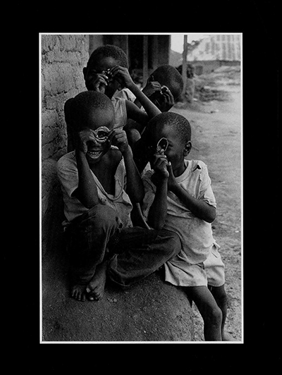 MM-G These children are trying to use something in place of a camera. One should encourage such children. But the parents didn't give them shoes. They will get worms. All this comes out of poverty. These children need help for a better life. 