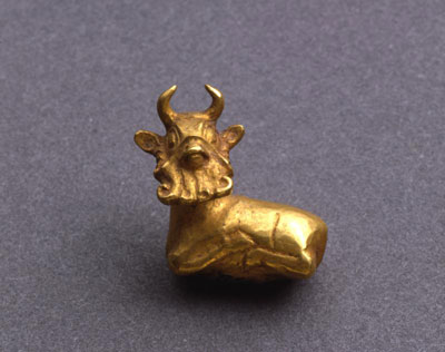 Small, gold amulet in the shape of a bearded bull.