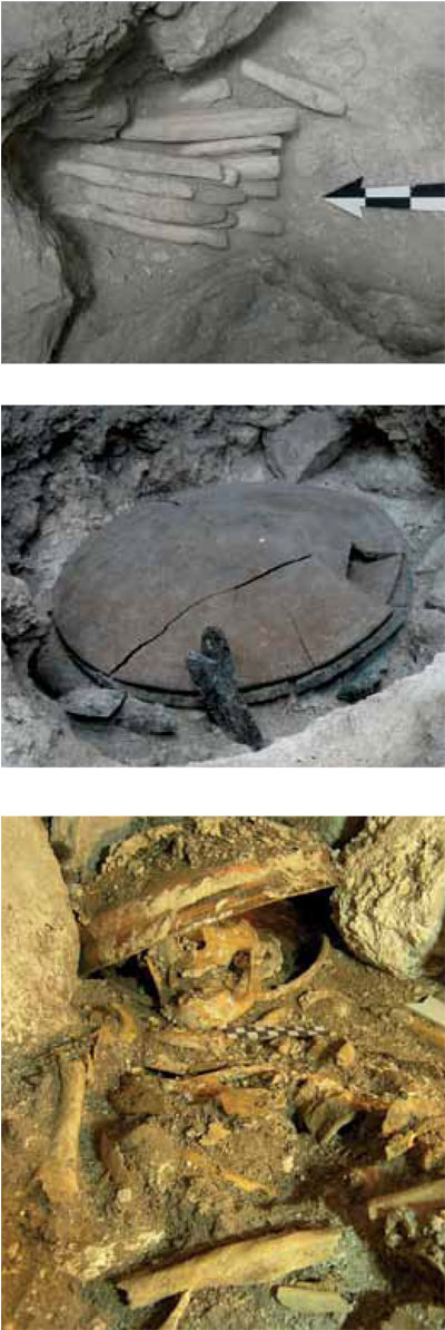 Limestone bars in situ. Knives around a plate in situ. Remains in a burial, the skull partially covered by a bowl.