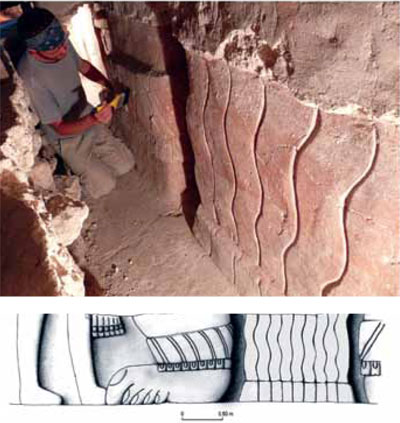 A person carefully uncovering a frieze depicting legs and an drawing of the depiction.