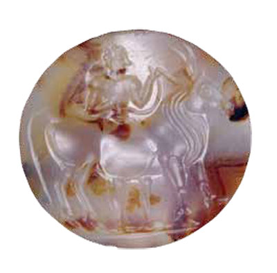 A circular seal made from a colorful agae, showing a person next to a bull.