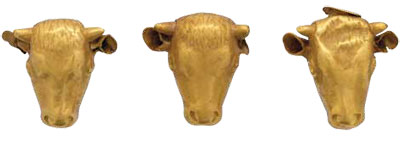 Three pieces of gold in the shape of bull heads, with nubby horns.
