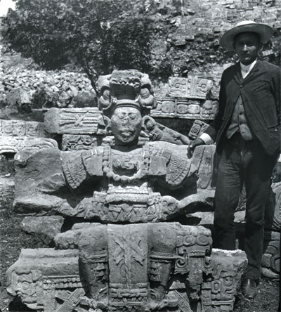 Honduran government representative Don Carlos Madrid stands next to a figure from the Hieroglyphic Stairway, ca. 1900.
