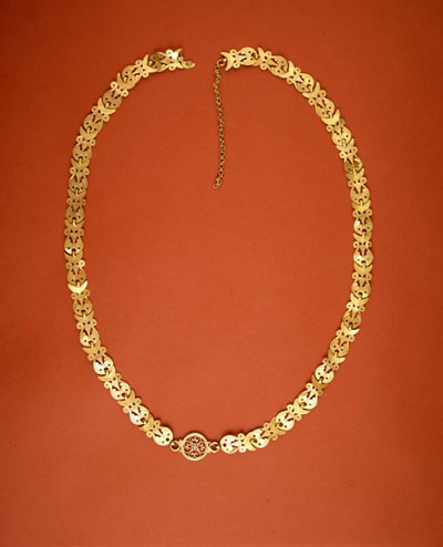 The gold necklace recovered from the floor level of Room H is a fine example of Byzantine pierced work. Museum Object Number: 31-50-212. 
