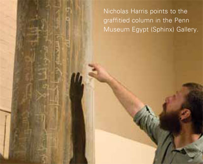 Nicholas Harris points to the  graffitied column in the Penn Museum Egypt (Sphinx) Gallery.