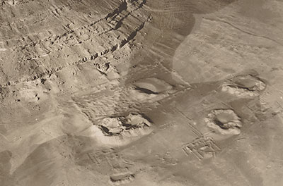 Looking southwest, this aerial photograph of the Senwosret III tomb enclosure at the base of the Mountain-of-Anubis was taken shortly after the early phase of work (1899–1903). Courtesy of the Egypt Exploration Society 