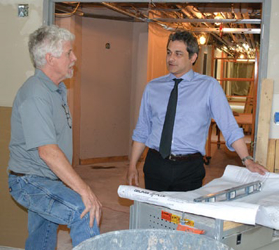 Director Julian Siggers (right) speaks with Mark Hopkins, superintendent for Lorenzo Brothers, about the new CAAM labs.