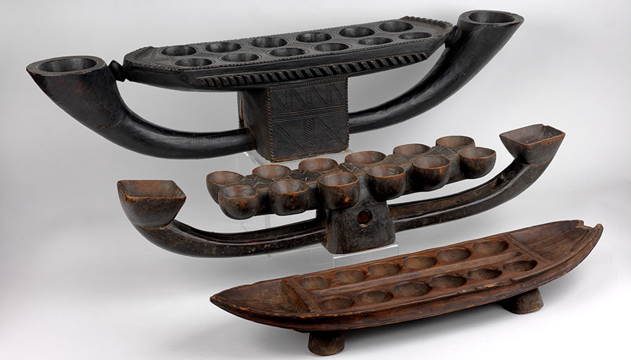 mall pebbles or shells were placed in the depressions of these wooden boat-shaped game boards from Liberia, in order to play a game still popular today called mancala. UPM object #2003- 63-9, 2003-63-4, and CG2001-8-154.