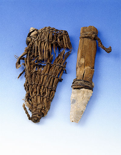 A small dagger with wooden handle and a woven sheath for it.