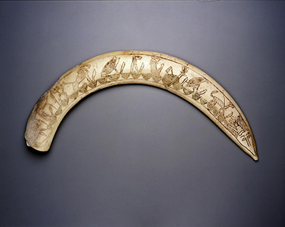 Wand carved from hippopotamus tusk. Decorated with a series of 9 magical figures (Seth, Taweret, Lion, Frog, Lion, Lion, gazelle(?), vulture, cat) each holding a knife. Each figure is seated atop the hieroglyph nb. At one end, there is a lion head at the other pointy end, a jackal head.