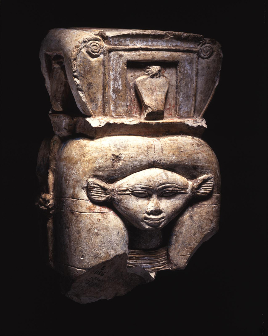 Painted limestone column capital in the form of a bifacial Hathor head. On her head, she wears a shrine with uraii in the recesses of the front, back, and sides. 