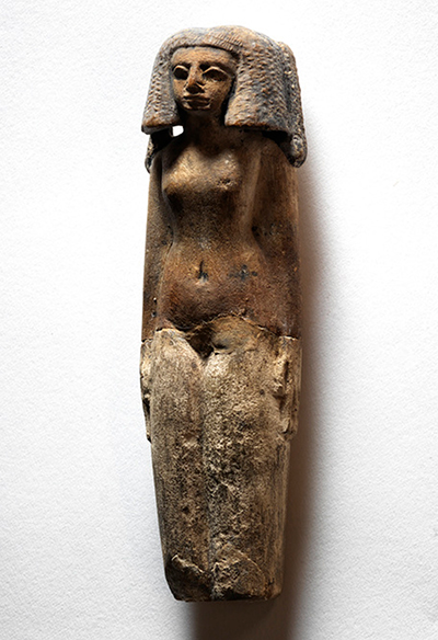 Statuette of a woman with painted tattoos and her arms at her side.