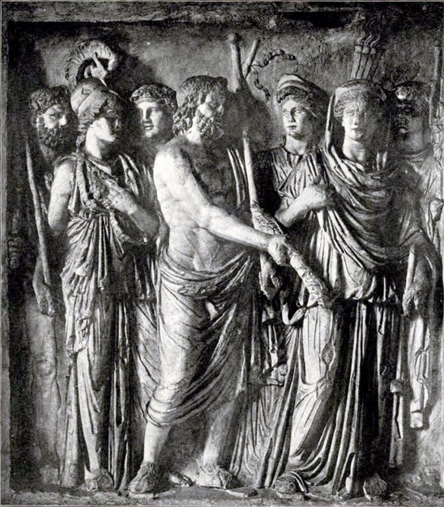 Stone relief on the Arch of Trajan depicting Jupiter in the center of a scene, with Juno on one side and Minerva on the other. Jupiter is handing off something in his grasp. Four people watch from behind the three main figures.