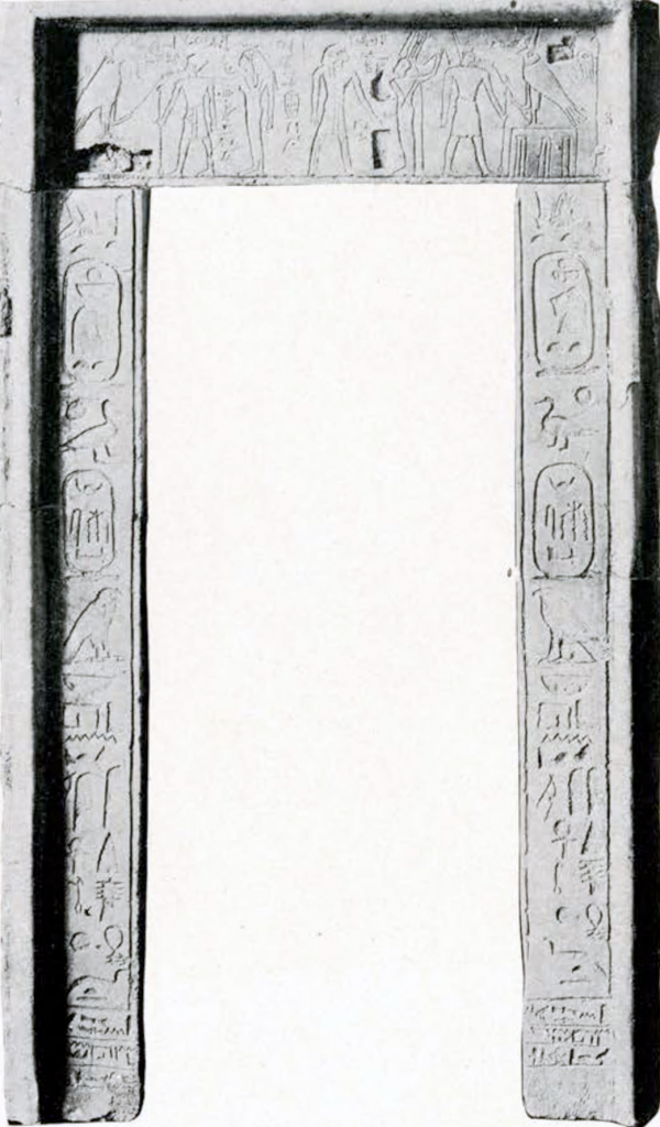 A temple doorway in its original form, reassembled from a few pieces. It is covered in hieroglyphic inscriptions.