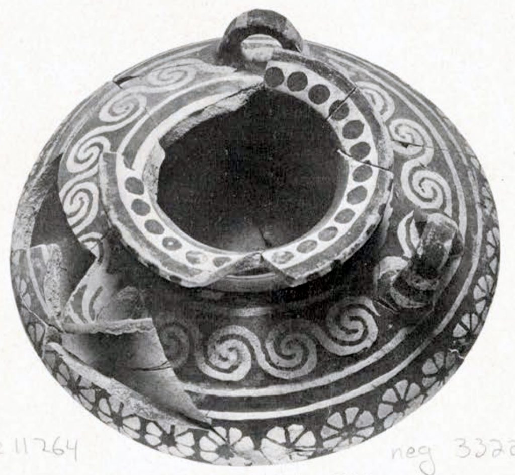 Black and white, ovaline Minoan jar with three handles, spiral and floral patterns