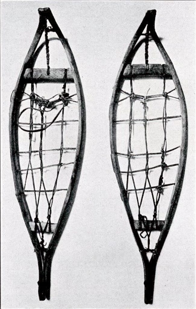 A pair of long, narrow snowshoes