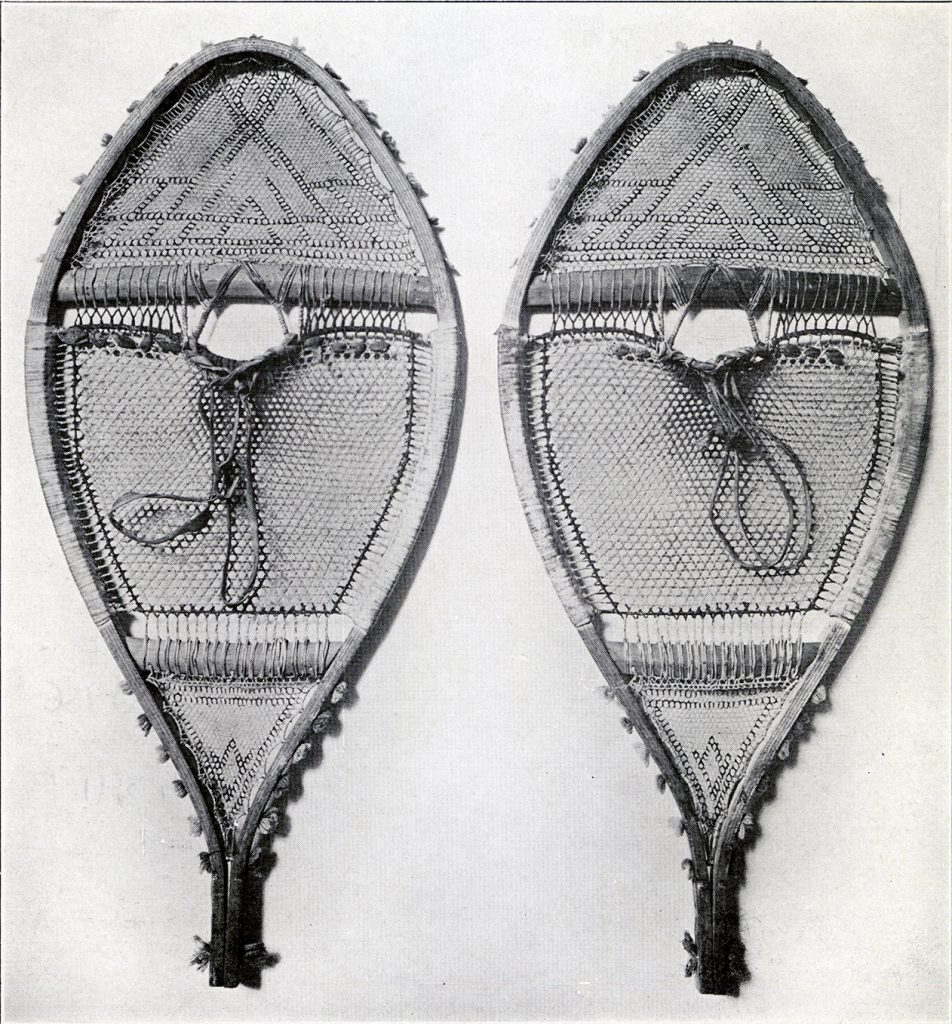 A pair of wide snowshoes with patterns made in the stitching