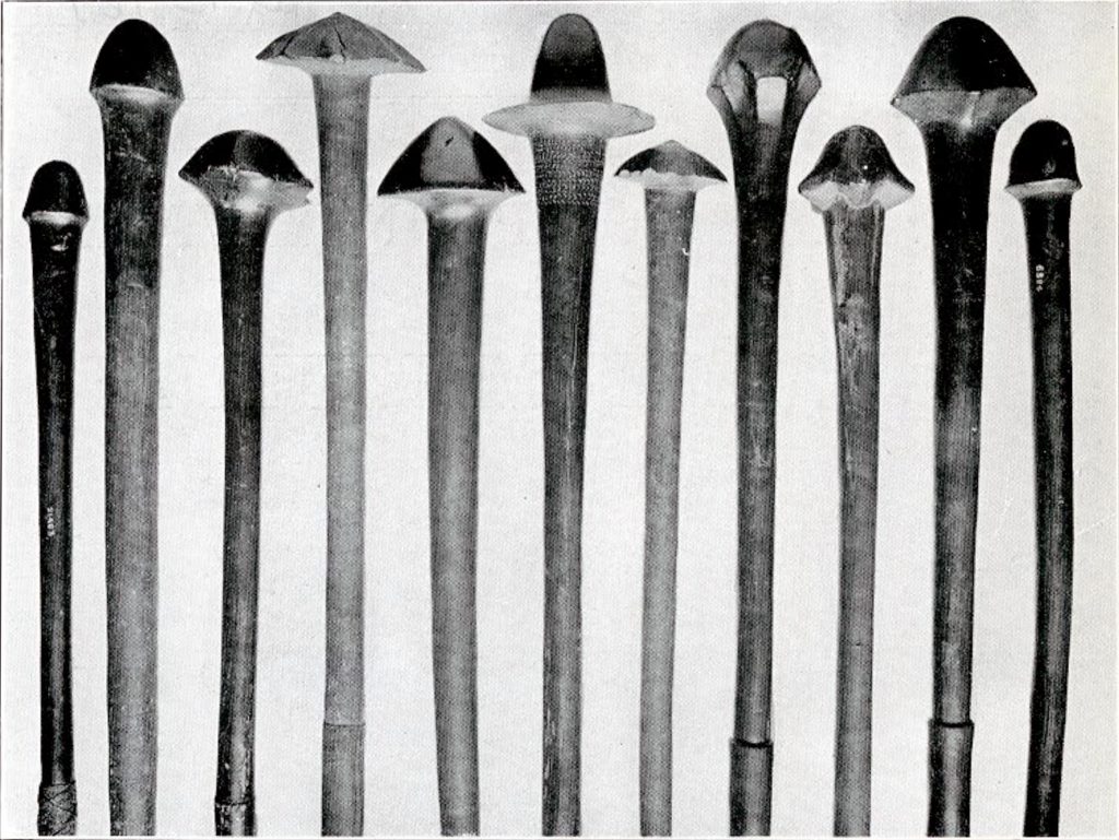 A set of eleven wooden clubs with mushroomcap ends